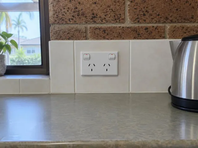 White double power point in a tiled kitchen splashback beside a window and benchtop in Burleigh Waters